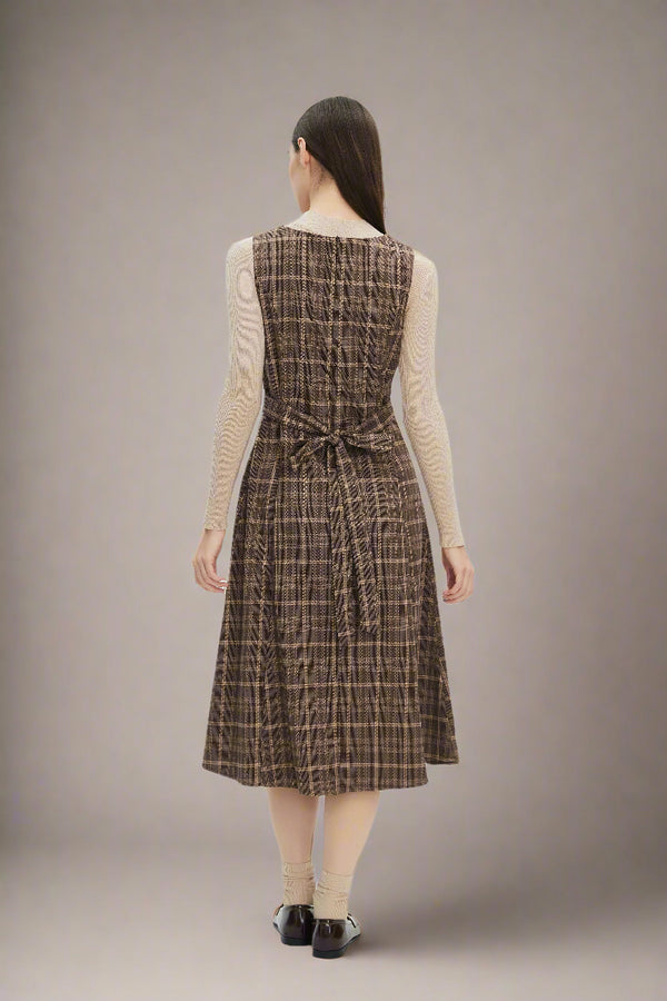Woman wearing a brown plaid dress
