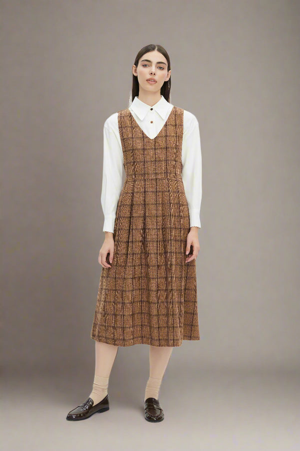 Woman wearing a brown checkered dress