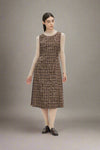 Woman wearing a brown plaid dress on a white background