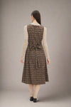 Woman wearing a brown plaid dress