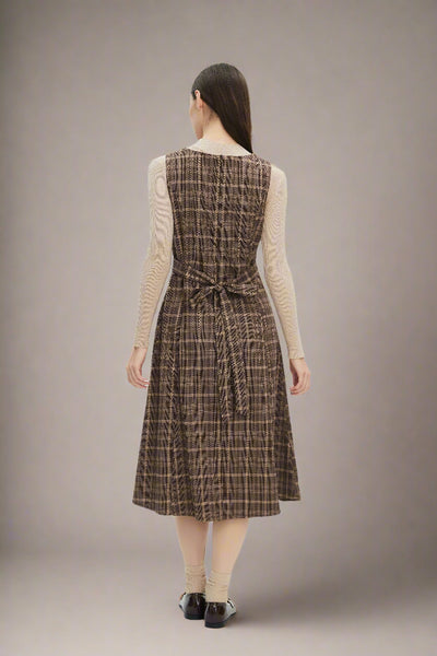 Woman wearing a brown plaid dress